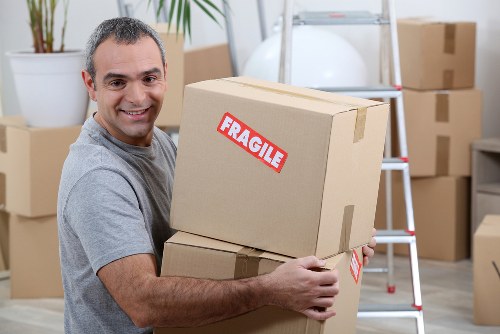Movers loading a truck with clear pricing details for a home relocation