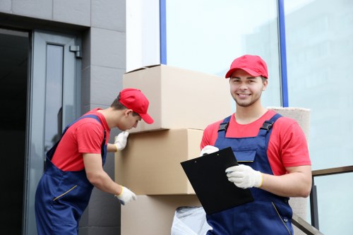 Man and van loading furniture for a move in Queens Park