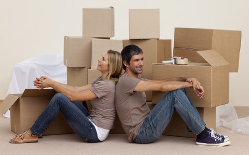 Loading furniture into a moving truck for a Queens Park relocation