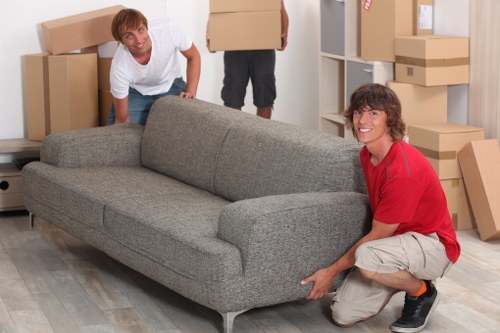Team loading bulky furniture for collection in Queenspark