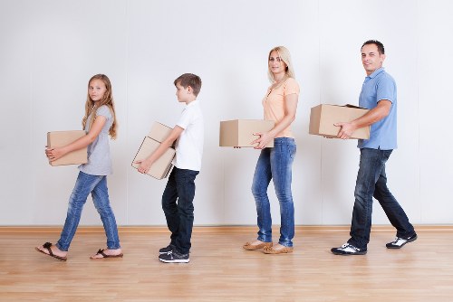 Professional movers loading furniture into a transport vehicle