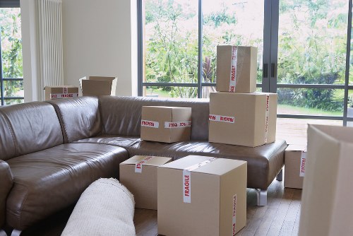Mover wearing PPE while handling furniture carefully during a house move