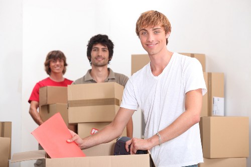 Professional movers carrying furniture in a local flat move